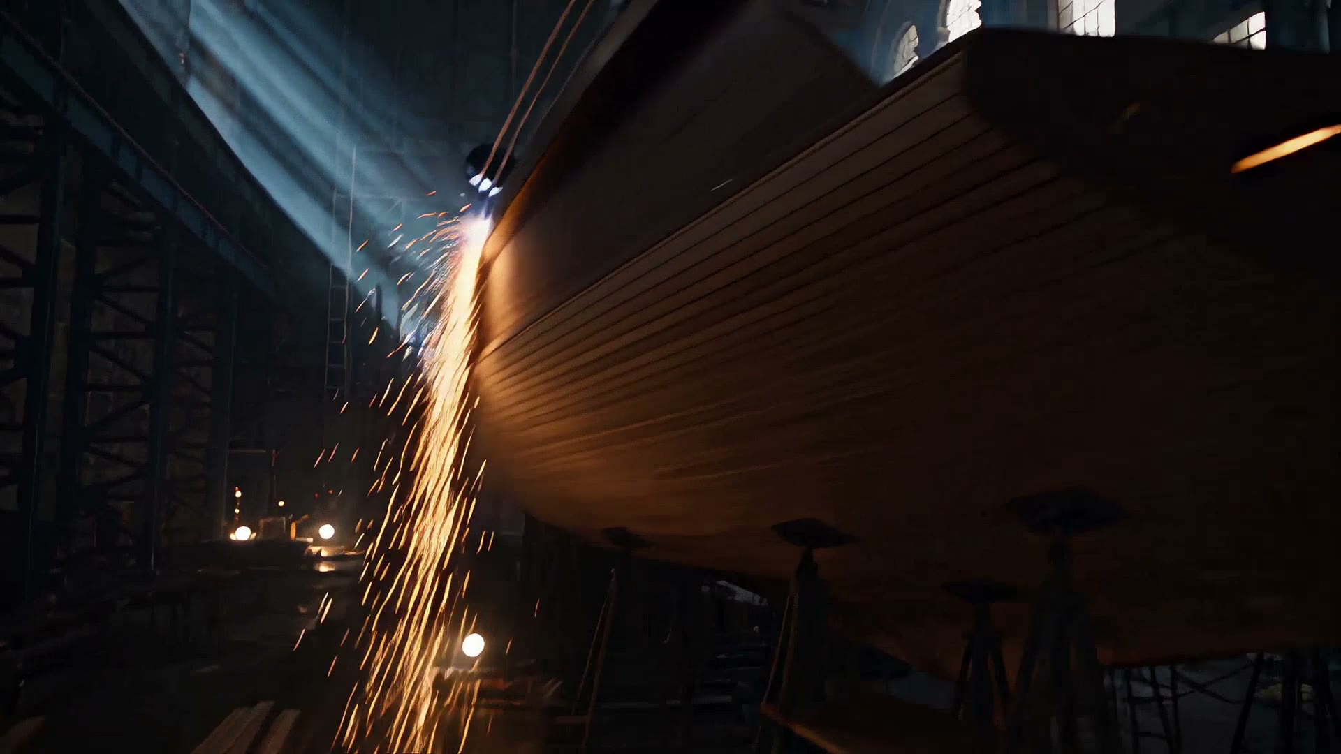 Sparks falling down the side of the hull during welding.