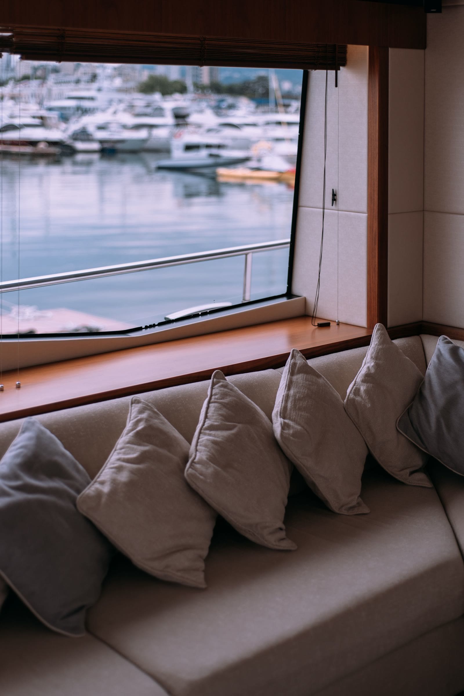 The saloon settee with cushions and a window onto the water.